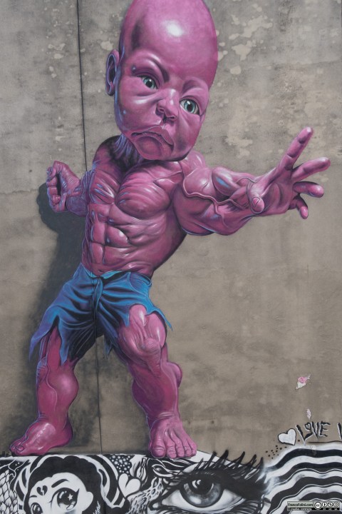 Pink Baby Hulk mural by Ron English on the wall of Mulberry Street Little Italy Manhattan New York USA