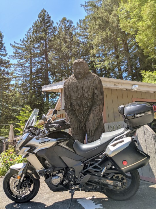 Kawasaki Versys 1000 LT in front of a huge Big Foot wooden sculpture. Myers Flats, California